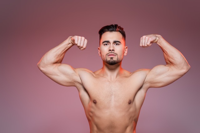Sildenafil Citrate Tablets : lighting on shirtless man showing muscles on pink and grey