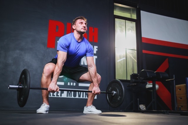 S4 Andarine Tablets-Bodybuilder bodybuilding with barbells in the gym. muscles workout bodybuilding concept
